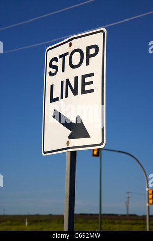 stop line sign at road junction intersection Saskatoon Saskatchewan Canada Stock Photo