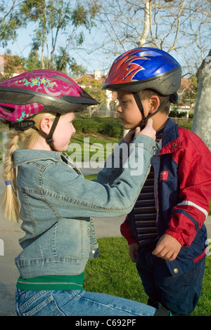 ethnic inter racial diversity racially diverse multicultural multi cultural interracial children child helping another adoption adopted brother. MR Stock Photo