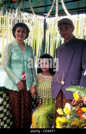 Javanese bride poses with her parents before the Siraman or washing ceremony of the wedding celebrations. Stock Photo