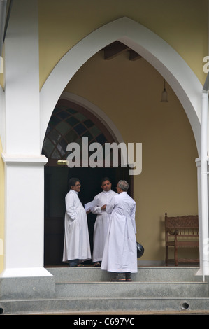 Three Catholic priests Bishops House Fort Cochin Kerala South India Stock Photo