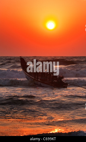 Indian fishermen setting off to sea at sunrise Stock Photo