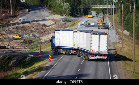 Roadworks on a highway divert traffic to a temporary road , Finland