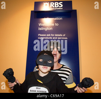 Activists from UK Uncut and Fight Racism, Fight Imperialism inside the Royal Bank of Scotland branch at the Angel in Islington Stock Photo