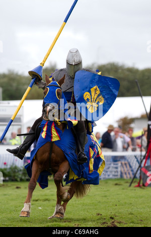 TV & film stuntman, JUSTIN PEARSON, performing with the spectacular Knights of the Damned jousting medieval display team, with galloping horses, stunts, falls, horsemanship, and skilful mounted knights at Southport Flower Show, UK Stock Photo