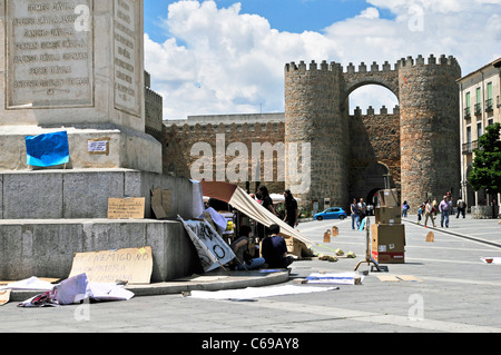 'Indignants' Protest Signs Against Backdrop of Medieval Avila Wall in Spain in Plaza Santa Teresa Stock Photo