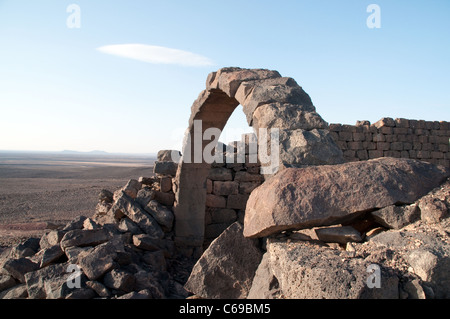 A view of Qasr Usaykhim, a Nabatean and Roman basalt stone fortress dating back to the 3rd century BC, in the Badia Eastern Desert region of Jordan. Stock Photo