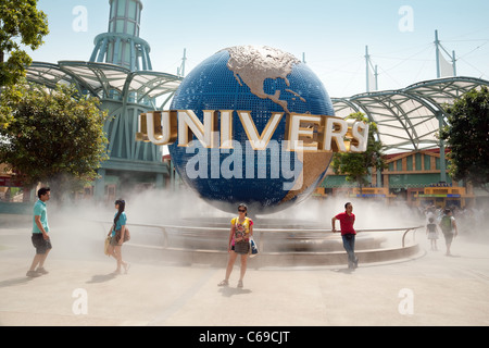 Tourists posing with the Universal Studios globe, Sentosa island, Universal Studios Singapore Asia Stock Photo