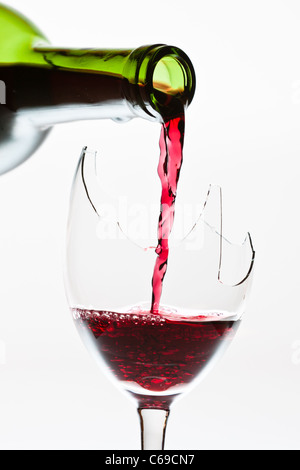 Wine in the the broken glass Stock Photo