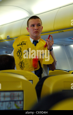 Steward showing safety informations at passengers of Ryanair Boeing 737 Stock Photo