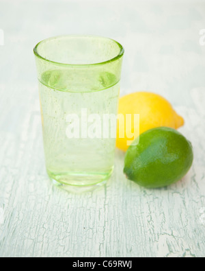 A glass of sparkling water with lemon and lime Stock Photo