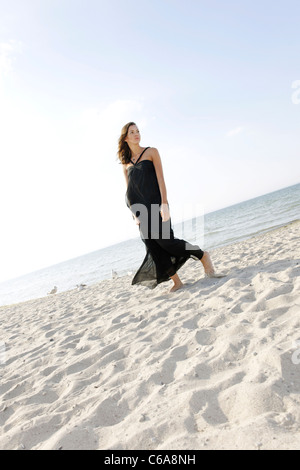 Young woman, 20+, standing in a long dress on the beach, lifestyle, sensuality, space, lightness, Niendorf at the Baltic Sea