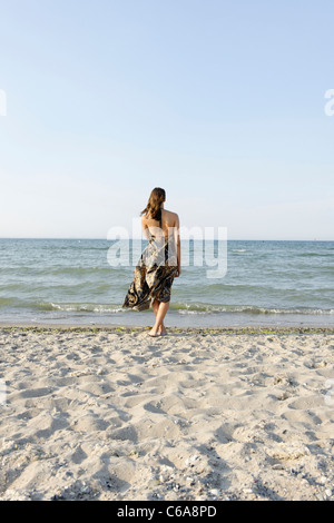 Young woman, 20+, standing in a long dress on the beach, lifestyle, sensuality, space, lightness, Niendorf at the Baltic Sea