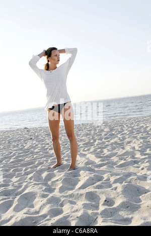 Young woman, 20+, standing on a sandy beach, lifestyle, sensuality, Niendorf at the Baltic Sea, Schleswig-Holstein, Germany