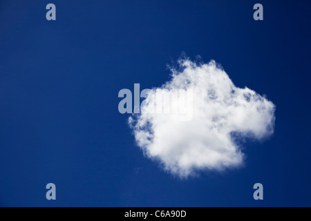 Blue sky and single lone cloud Stock Photo
