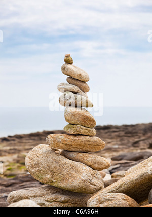 Pebbles balanced in a pile on a beach Stock Photo