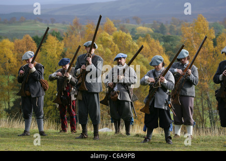 Members of [Fraser's Dragoons], a 17th century re-enactment society, loading their muskets Stock Photo