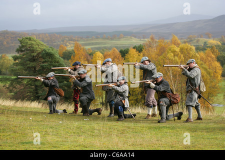 Members of [Fraser's Dragoons], a 17th century re-enactment society, about to fire a volley of muskets Stock Photo