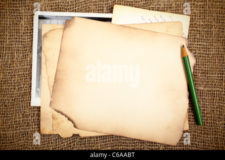 Stack of old papers and photos on a wooden table Stock Photo