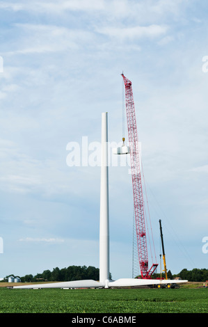 Construction workers assemble the hub for a horizontal-axis wind turbine on a tower near Lakefield, Minnesota. Stock Photo