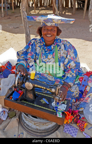 Herero woman sewing, Damaraland, Namibia Stock Photo