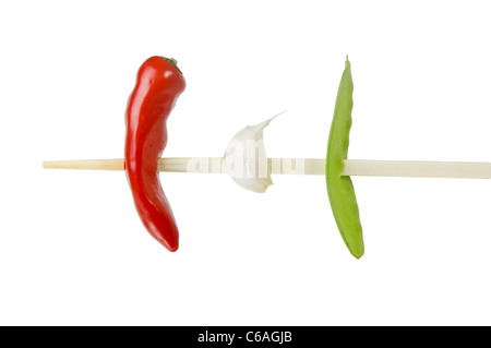 Chili, garlic and mangetout on a chopstick Stock Photo