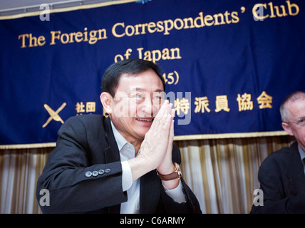 Thaksin Shinawatra, former prime minister of Thailand, makes a traditional greeting before of a news conference in Tokyo Stock Photo