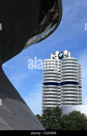 The BMW headquarters tower, seen past the BMW Welt (BMW World) building, in Munich, Bavaria, Germany. Stock Photo