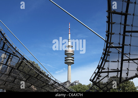 The Munich Television Tower (Fernsehturm) seen through a gap in the roofing of the Olympic Stadium in Munich, Bavaria, Germany. Stock Photo