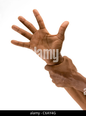 African's outstretched hand being gripped at the wrist by another hand. . Studio shot on white background. Stock Photo