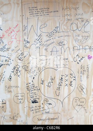 The aftermath of the riots in the Clapham Junction area.  People write messages of support on boards covering damage. Stock Photo