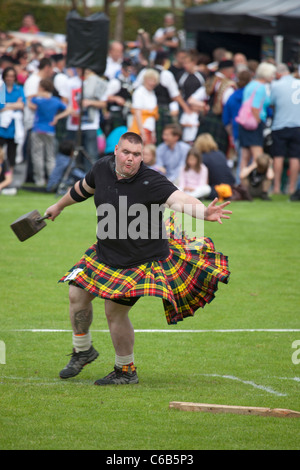 Kilted heavyweight athlete in the 'throwing a 56lb weight' competition, a 'heavy event' at Brodick Highland Games, Arran Stock Photo