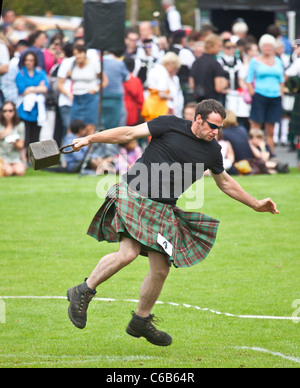 Kilted athlete in the 'throwing a 56lb weight' competition, one of the 'heavy events' at Brodick Highland Games, Arran Stock Photo