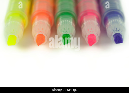 Close up of colorful highlighters lined up isolated on white Stock Photo