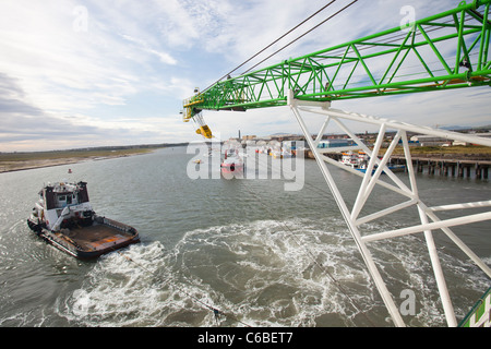 A tug boat towing a jack up barge, the Goliath, out to work on the Walney offshore wind farm off south Cumbria, UK. Stock Photo