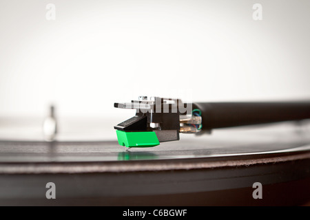 A record player and tone arm with cartridge and vinyl record Stock Photo