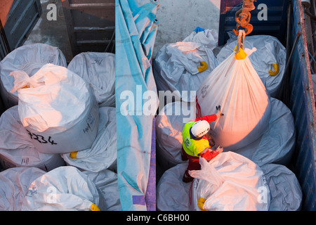 A crane operator using a remote control unit. Stock Photo