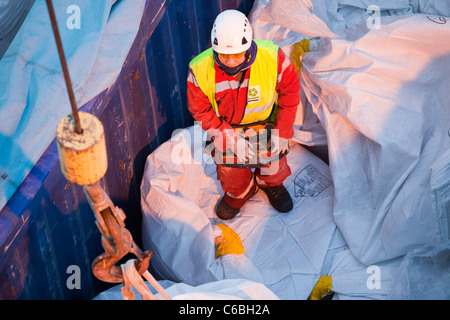 A crane operator using a remote control unit. Stock Photo