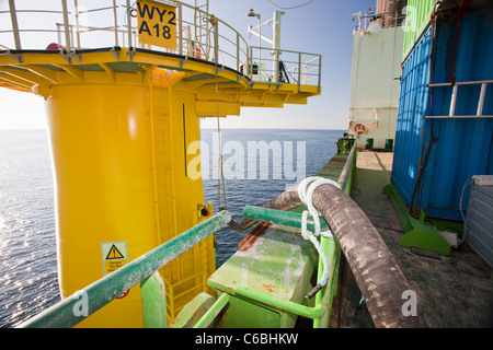 A pipe carries specialist grout to cement a transition piece to a monopile, on the Walney offshore windfarm. Stock Photo