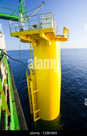 A pipe carries specialist grout to cement a transition piece to a monopile, on the Walney offshore windfarm. Stock Photo