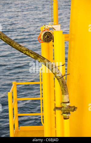 A pipe carries specialist grout to cement a transition piece to a monopile, on the Walney offshore windfarm. Stock Photo