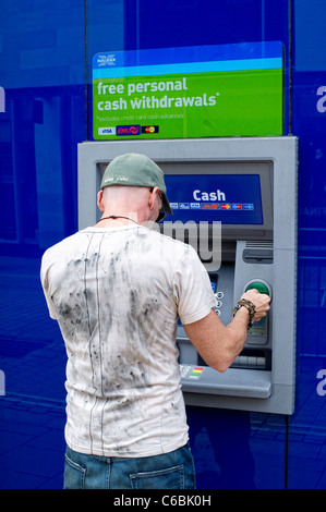 Man using Halifax (HBos) cash dispenser (ATM) Stock Photo