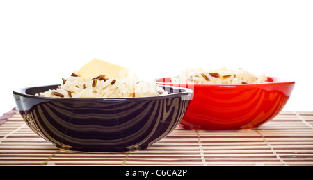 bowls with cooked rice and butter on bamboo napkin Stock Photo