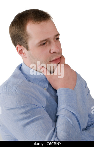 The man in a blue shirt thoughtfully rubs a chin, is isolated on a white background Stock Photo