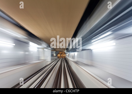 Opened in 2010, the Dubai Metro, MRT, in motion approaching a station, Dubai, United Arab Emirates Stock Photo