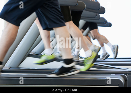 People running on treadmills in health club Stock Photo