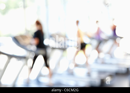 Defocused view of people on treadmills in health club Stock Photo