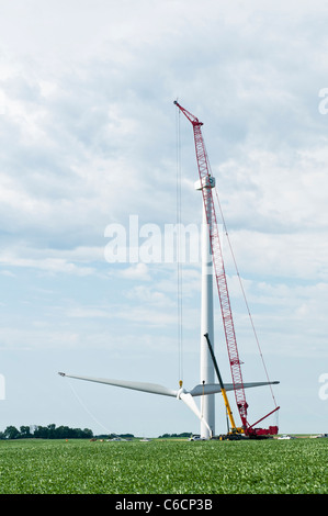 Construction workers assemble the rotor for a horizontal-axis wind turbine on a tower near Lakefield, Minnesota. Stock Photo