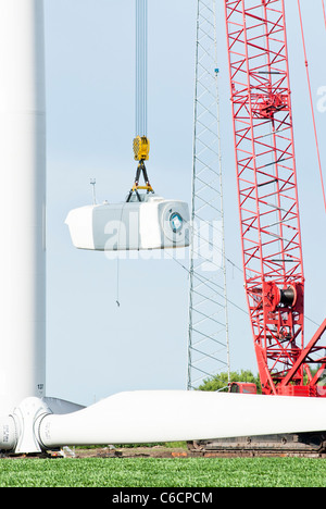 Construction workers assemble the hub for a horizontal-axis wind turbine on a tower near Lakefield, Minnesota. Stock Photo