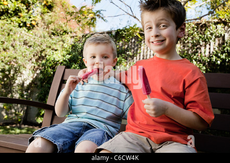 Caucasian brothers eating popsicles Stock Photo