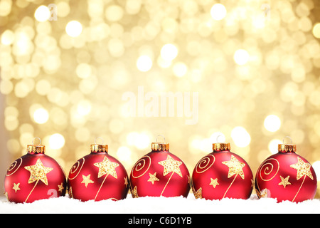Row of shiny red christmas balls on abstract light background. Stock Photo